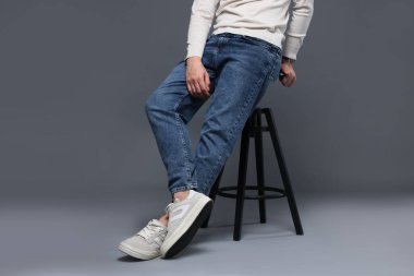 Gri arka planda kotlu şık bir adam, yakın plan.