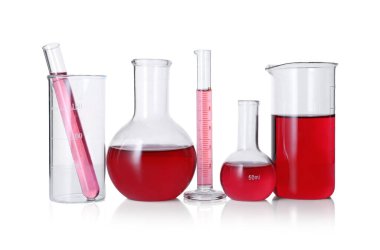 Different laboratory glassware with red liquid isolated on white
