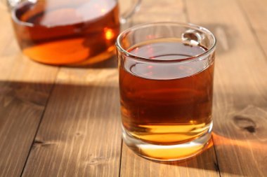 Ahşap masada fincanda siyah çay, yakın plan.