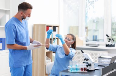 Research in genetics. Scientists working with samples in laboratory
