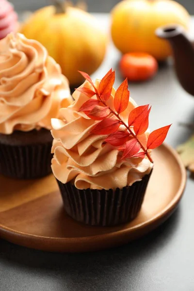 Gri masa üzerinde kırmızı yaprakları olan lezzetli kekler, yakın plan. Sonbahar atmosferi