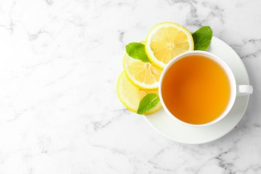Beyaz mermer masada limonlu ve nane şekerli Aromatik çay, üst manzara. Metin için boşluk