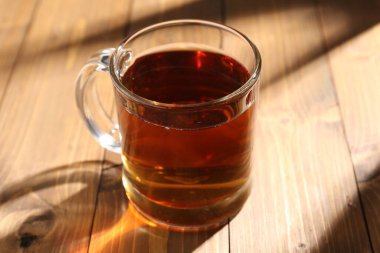 Ahşap masada fincanda siyah çay, yakın plan.