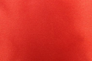 Beautiful red ribbon as background, top view