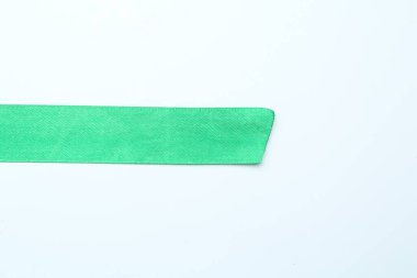 Beyaz arka planda güzel, açık yeşil kurdele, üst manzara. Metin için boşluk