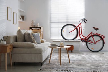 Kırmızı bisiklet, kanepe ve dekor odada.
