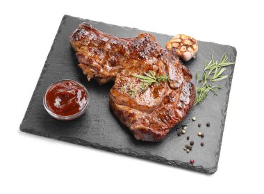 Delicious grilled beef steak with herbs, spices and ketchup isolated on white