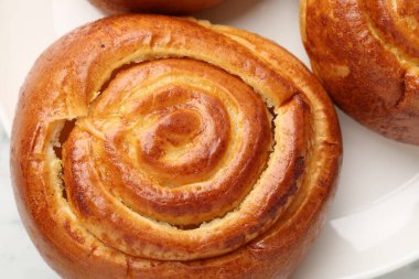 Tasty roll buns on plate, top view