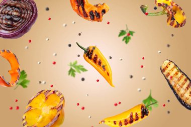 Grilled vegetables, parsley and peppercorns falling on beige gradient background