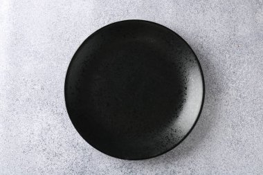 One stylish plate on grey table, top view