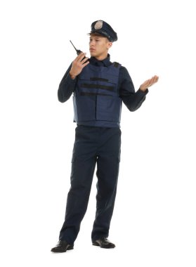 Beyaz arka planda telsizi olan üniformalı genç bir polis.