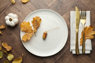 Beautiful table setting with autumn decor on wooden background, flat lay