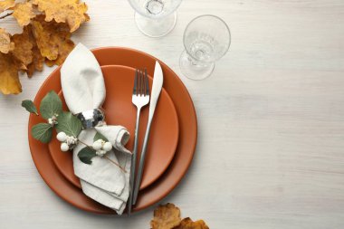 Beautiful table setting with autumn decor on white wooden background, flat lay. Space for text