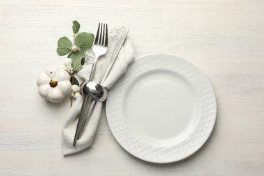 Beautiful table setting with autumn decor on white wooden background, flat lay