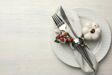 Beautiful table setting with autumn decor on white wooden background, top view. Space for text