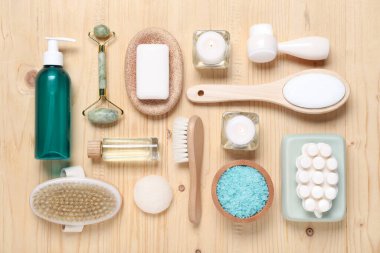 Flat lay composition with spa products and burning candles on wooden table