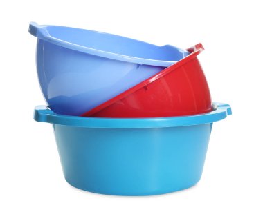 Three colorful plastic basins isolated on white