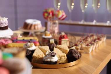 Buffet menu. Different delicious desserts on table, selective focus