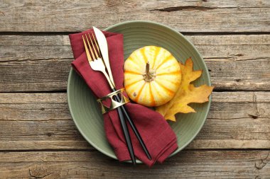 Beautiful table setting with autumn decor on wooden background, top view
