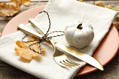 Beautiful table setting with autumn decor on wooden background, closeup