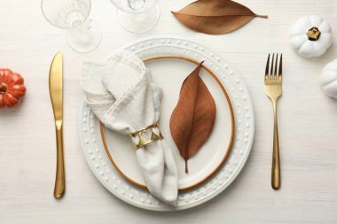 Beautiful table setting with autumn decor on white wooden background, flat lay