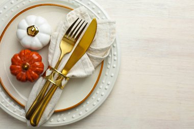 Beautiful table setting with autumn decor on white wooden background, top view. Space for text