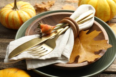 Beautiful table setting with autumn decor on wooden background, closeup
