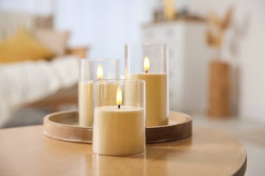 Evdeki ahşap masada dekoratif LED mumlar, yakın plan.