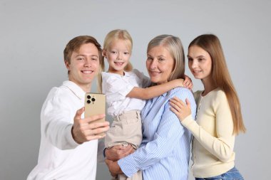 Anne ve babasıyla özçekim yapan bir adam.