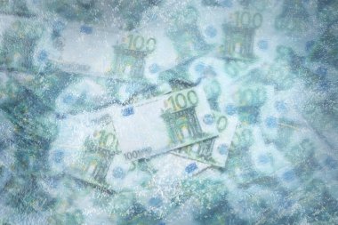 Money frozen. Many euro bills under ice