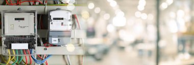 Electricity meters and wires in fuse box indoors. Banner design