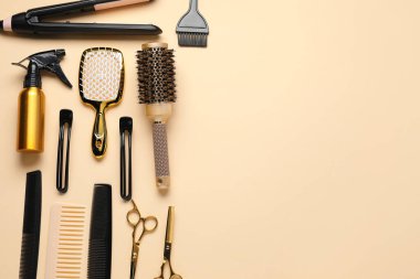 Different hair styling tools on beige background, flat lay. Space for text