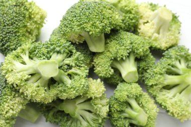 Fresh green broccoli on white table, closeup