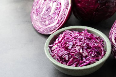 Fresh red cabbage on grey table, closeup. Space for text