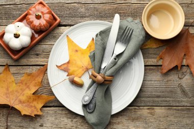 Beautiful table setting with autumn decor on wooden background, flat lay