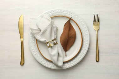 Beautiful table setting with autumn decor on white wooden background, flat lay