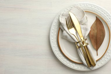 Beautiful table setting with autumn decor on white wooden background, top view. Space for text