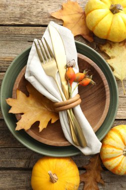 Beautiful table setting with autumn decor on wooden background, flat lay
