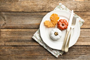 Beautiful table setting with autumn decor on wooden background, top view. Space for text