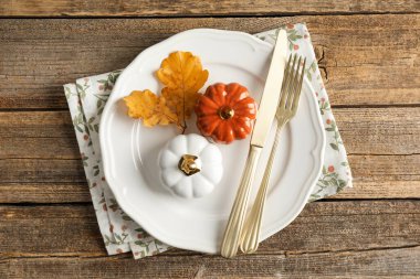 Beautiful table setting with autumn decor on wooden background, top view