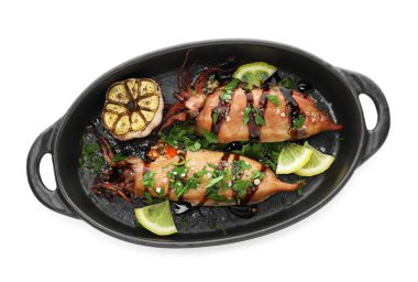 Tasty cooked squids with lemon, sauce and garlic isolated on white, top view