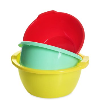 Three colorful plastic basins isolated on white