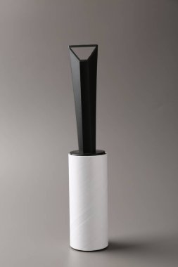 One sticky lint roller on grey background