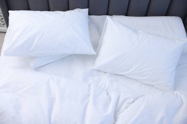 Bed with fresh white linens indoors, above view