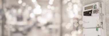 Electricity meter on wall indoors. Banner design