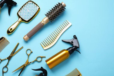 Different hair styling tools on light blue background, flat lay. Space for text