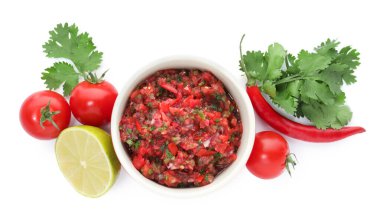 Delicious salsa sauce in bowl and ingredients isolated on white, top view