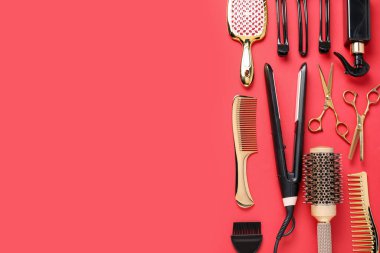 Different hair styling tools on red background, flat lay. Space for text