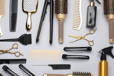 Different hair styling tools on white background, flat lay