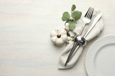 Beautiful table setting with autumn decor on white wooden background, flat lay. Space for text